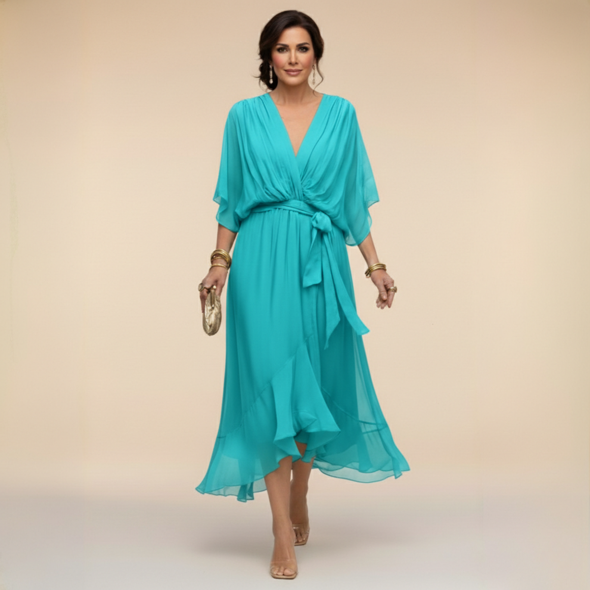 Woman wearing a turquoise dress on a beige background