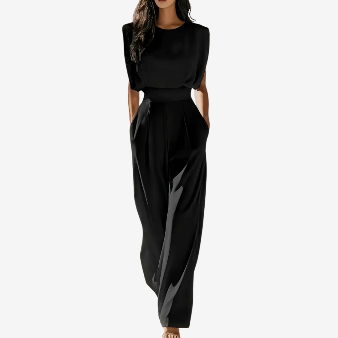 Black jumpsuit worn by a model on a white background