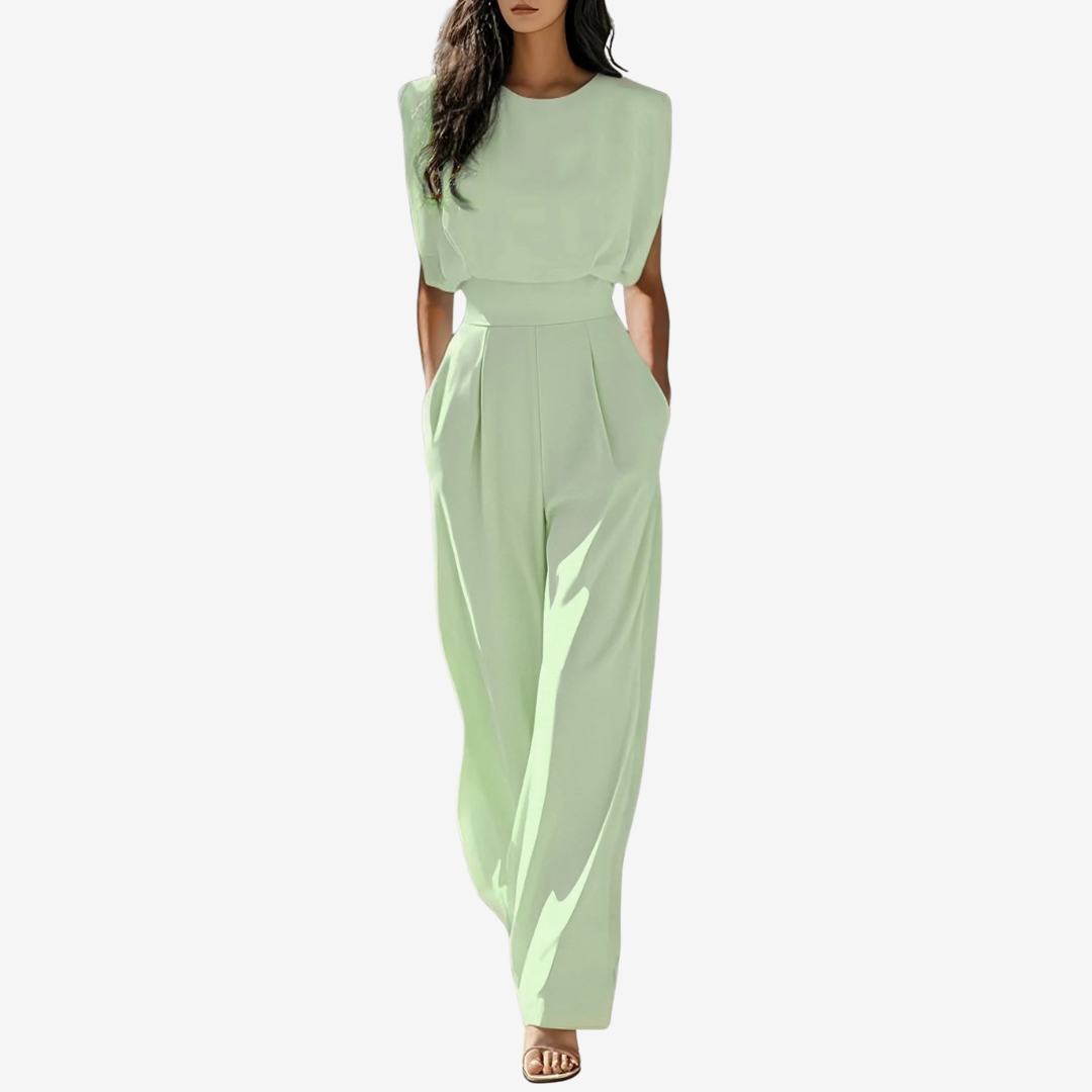 Woman wearing a beige jumpsuit on a white background