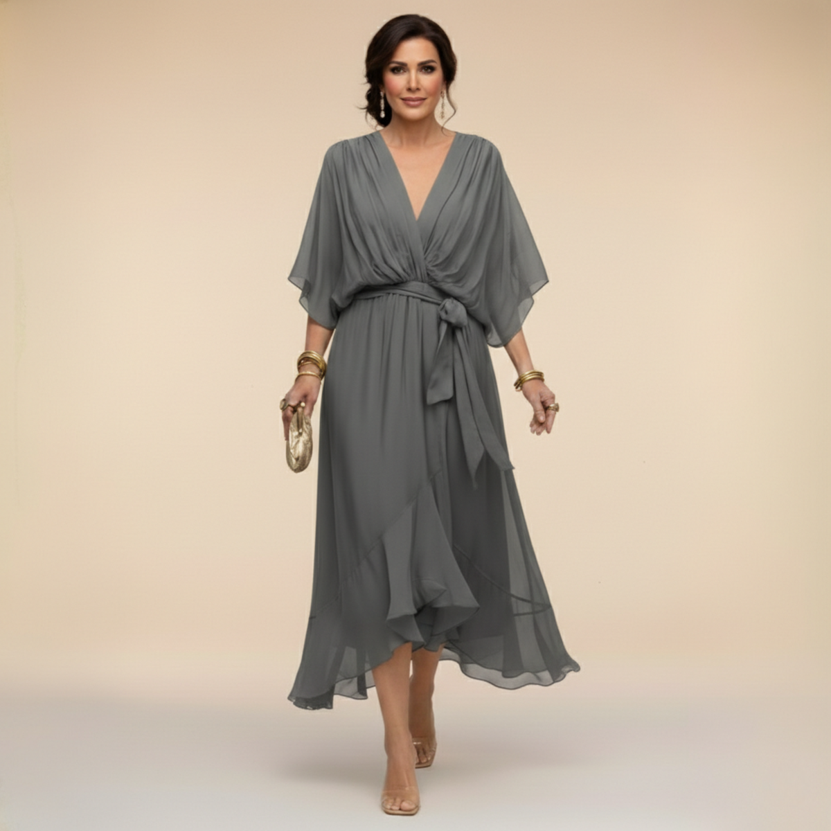 Woman wearing a gray dress with a plain background