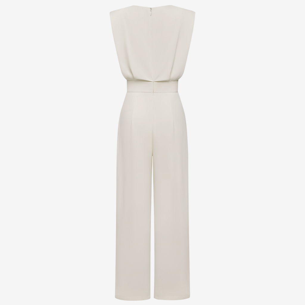 White jumpsuit on a light beige background