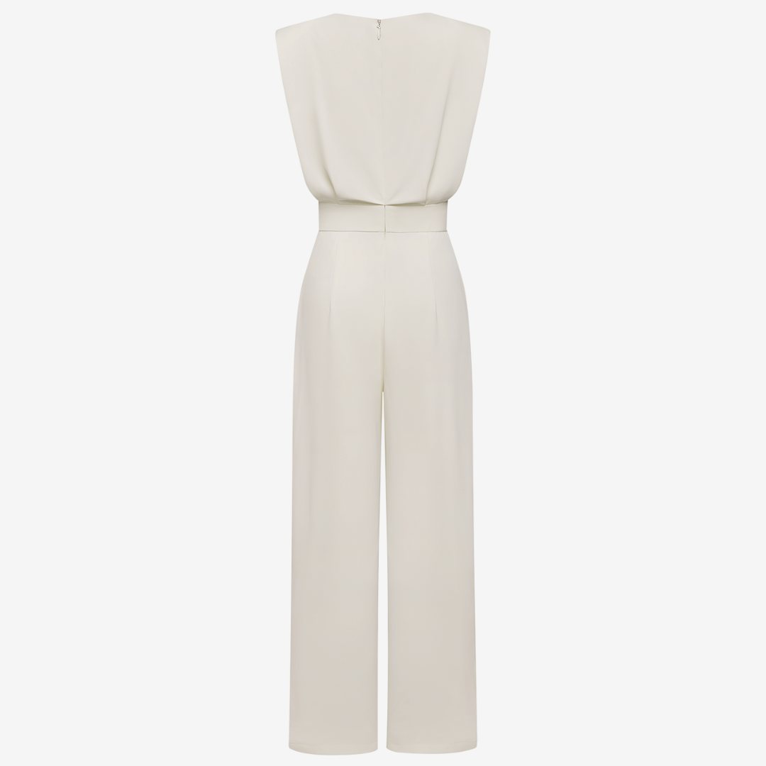 White jumpsuit on a light beige background