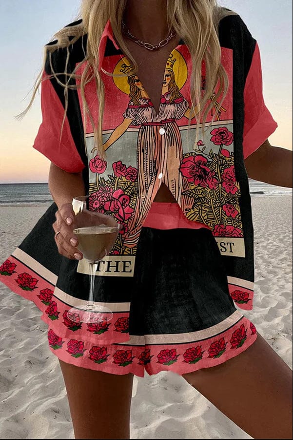 Person on a beach wearing a colorful outfit with floral patterns and a glass of drink.